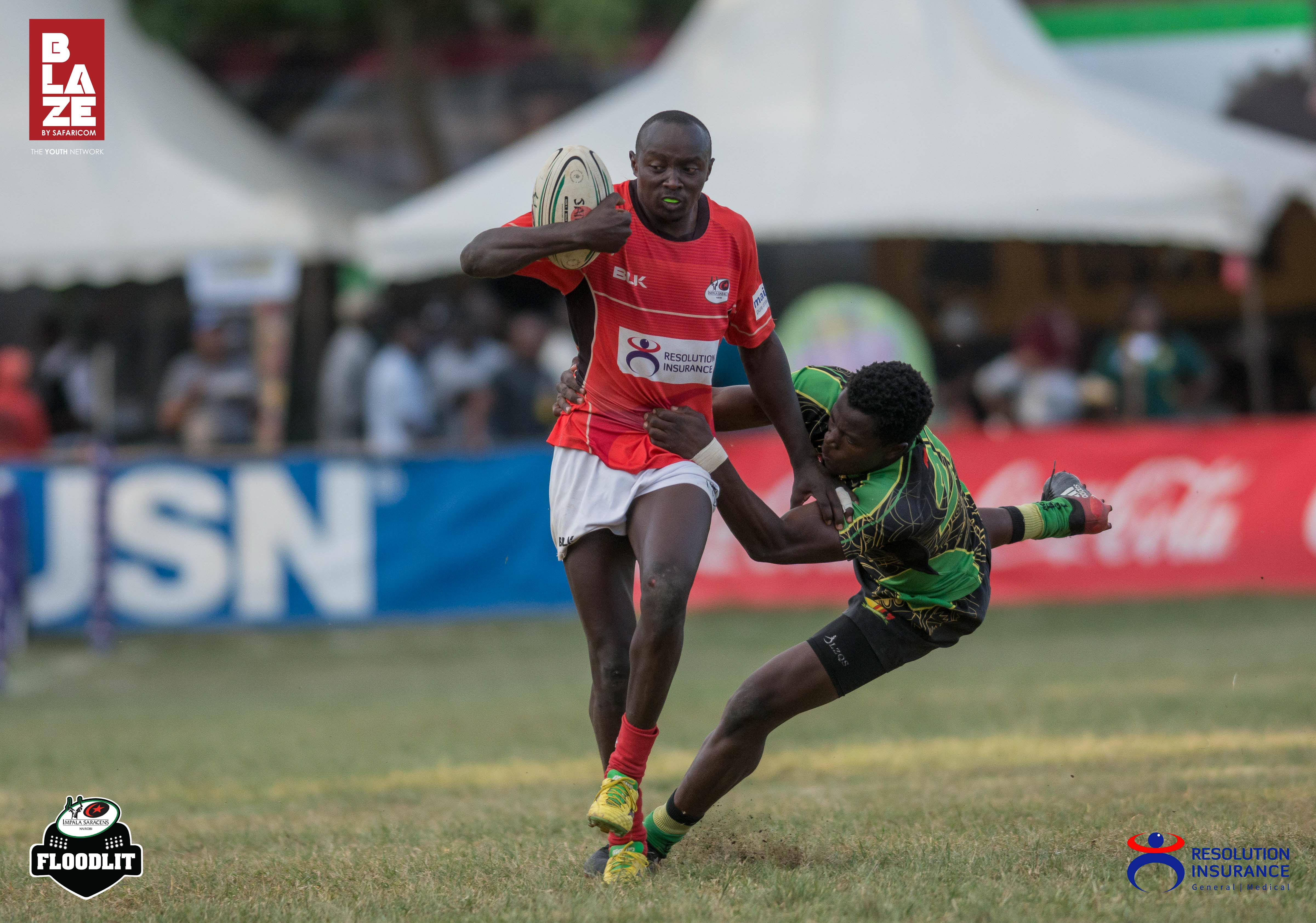 Mark Kwemoi of Resolution Impala Saracens brushing off a tackle from John Okoth of Top Fry Nakuru.